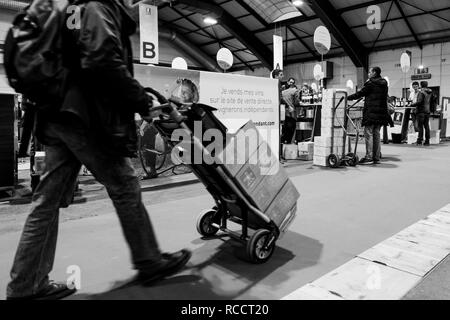STRASBOURG, FRANCE - FEB 19, 2018: Customers transporting French wine boxes at the Vignerons independant English: Independent winemakers of France wine fair in Strasbourg Stock Photo