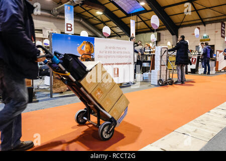 STRASBOURG, FRANCE - FEB 19, 2018: Customers transporting French wine boxes at the Vignerons independant English: Independent winemakers of France wine fair in Strasbourg Stock Photo