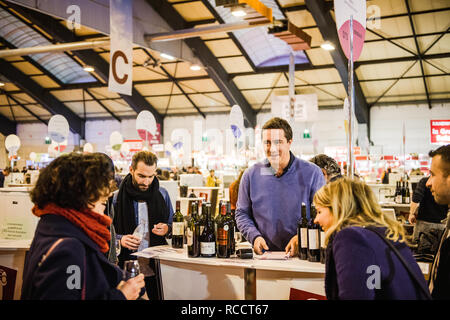 STRASBOURG, FRANCE - FEB 19, 2018: Man selling French wine at the Vignerons independant English: Independent winemakers of France wine fair in Strasbourg to customers Stock Photo