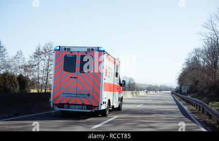 ACHERN GERMANY - FEB 18, 2018: Fast driving in front Deutsches Rotes Kreuz ambulance on German rural road Stock Photo