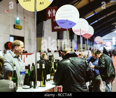 STRASBOURG, FRANCE - FEB 19, 2018: Man buying French wine at the Vignerons independant English: Independent winemakers of France wine fair in Strasbourg Stock Photo