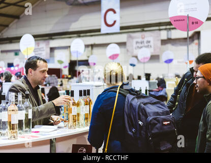 STRASBOURG, FRANCE - FEB 19, 2018: Adult woman tasting and buying French wine at the Vignerons independant wine fair Stock Photo