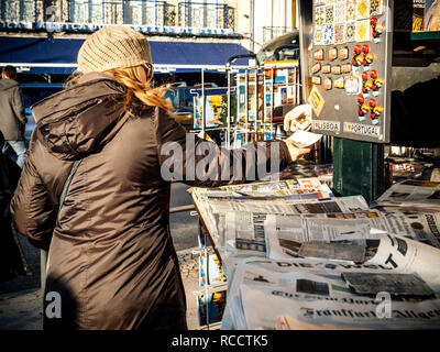 LISBON, PORTUGAL - FEB 10, 2018: Woman receiving change at press kiosk after buying fresh newspaper in central Lisbon  Stock Photo