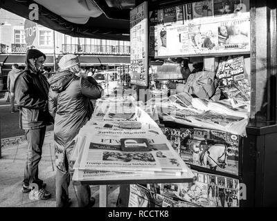 LISBON, PORTUGAL - FEB 10, 2018: Couple buying newspapers at the Lisbon Press kiosk  Stock Photo