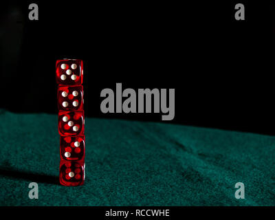 Several red dice with white dots on a green mat Stock Photo