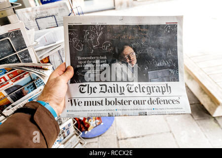 PARIS, FRANCE - MAR 15, 2018: International newspaper The Daily Telegrph with portrait of Stephen Hawking the English theoretical physicist, cosmologist dead on 14 March 2018 Stock Photo