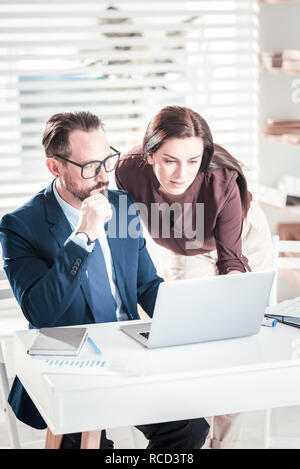 Focused two colleagues joining efforts Stock Photo