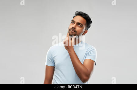 indian man thinking and looking up Stock Photo