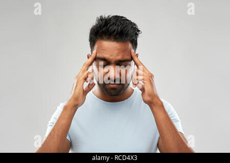 unhappy indian man suffering from headache Stock Photo