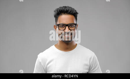 happy indian man in eyeglasses or student Stock Photo