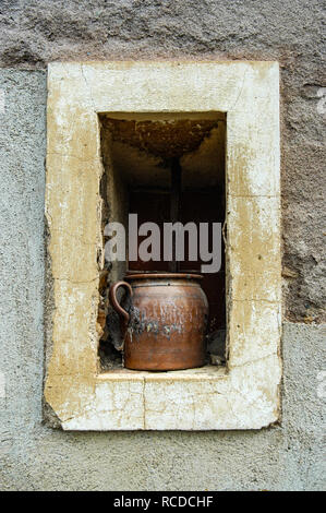 Large pot sitting on the window ledge of an old French stone house Stock Photo
