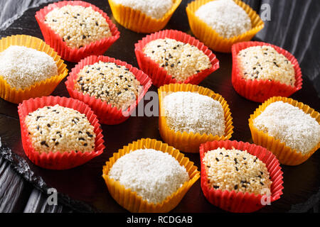 Japanese dessert Daifuku peanut sesame Mochi and mung bean close-up on the table. horizontal Stock Photo