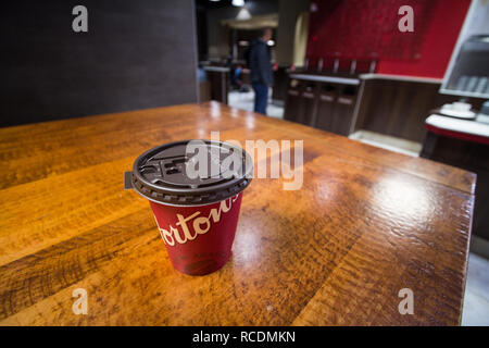 MONTREAL, CANADA - NOVEMBER 9, 2018: Close up on a cardboard coffee cup with Tim Hortons logo in one of their restaurants in Montreal, Quebec. Tim Hor Stock Photo