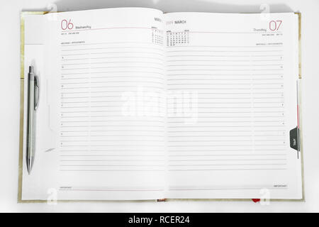 Picture of open diary with pen. Isolated on the white background. Stock Photo
