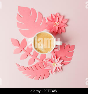 Handcraft plant corner from live coral paper with tropical leaf and coffee.  A modern handmade paper application from colored paper on pink background Stock Photo