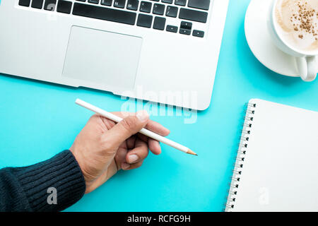 Male hand holding pencil with notepaper Stock Photo