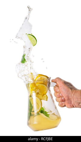 Jug with lemonade splash in hand Stock Photo