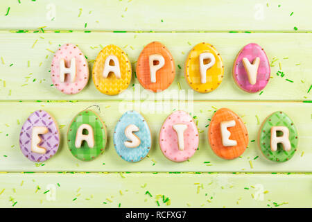 Easter background - cookies shaped like eggs, flowers, bunnies, top view Stock Photo