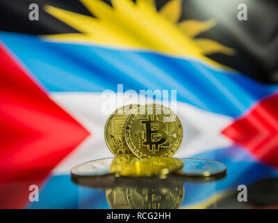 Bitcoin gold coin and defocused flag of Antigua and Barbuda background. Stock Photo