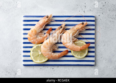 Cooked tiger prawns on blue and white rectangular plate, top view Stock Photo