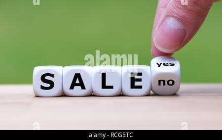 On sale? Hand turns a dice and changes the word 'no' to 'yes' Stock Photo