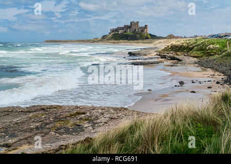 Looking along beach, coast to Bamburgh, Castle,  Northumberland, England, UK Stock Photo