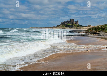 Looking along beach, coast to Bamburgh, Castle,  Northumberland, England, UK Stock Photo