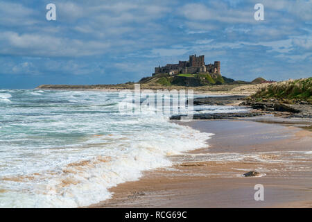 Looking along beach, coast to Bamburgh, Castle,  Northumberland, England, UK Stock Photo