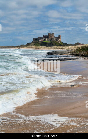 Looking along beach, coast to Bamburgh, Castle,  Northumberland, England, UK Stock Photo