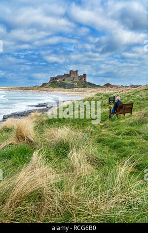 Looking along beach, coast to Bamburgh, Castle,  Northumberland, England, UK Stock Photo