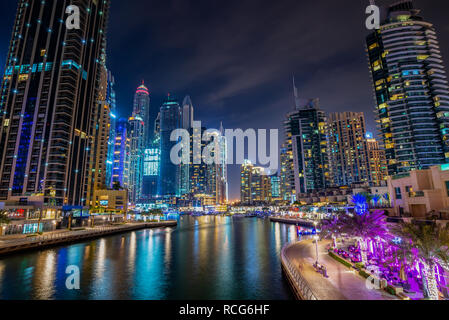 Dubai marina walk at night with illuminated buildings, United Arab Emirates