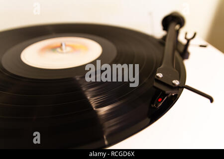 Vinyl lp record playing on a turntable isolated Stock Photo