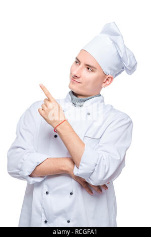 cook in uniform points his finger at something to the side, portrait on white background isolated Stock Photo
