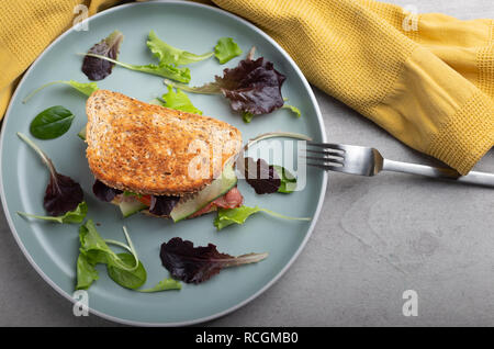 homemade toast with bacon,cheese tomatoes and salad on a plate Stock Photo