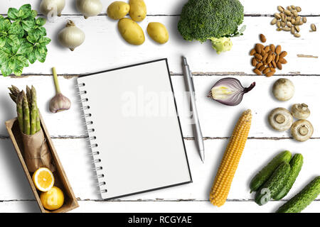 empty notepad and many cooking ingredients on white wooden background Stock Photo