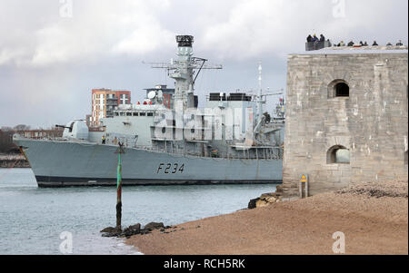 HMS Iron Duke, a Royal Navy Type-23 frigate, makes her way past the Round Tower as she is towed out of Portsmouth harbour down to HMNB Devonport for her refit Stock Photo