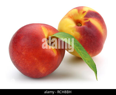 Nectarine peaches with leaf isolated on white background Stock Photo