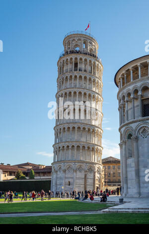 January 01, 2019 Pisa, Tuscany, Italy - Leaning Tower of Pisa and a side of the Pisa Cathedral viewed behind the Pisa Cathedral, viewed from the north Stock Photo