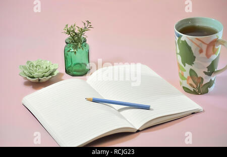 Blank Notebook with Coffee and Plants on Pink Background Stock Photo