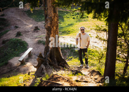 Man using hiking with backpack outdoors in woods Stock Photo
