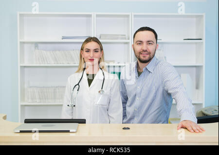 Young male doctor with colleague at doctor's office. Doctor. Work. Boss. Stock Photo