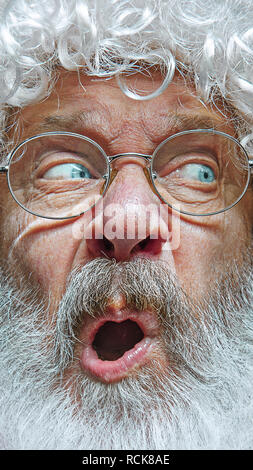 Handsome senior man skeptic and nervous, frowning upset because of problem. Negative person. The emotional face of Santa Clause in glasses. The holiday, expression, emotions, senior, winter, gesture concept. Stock Photo