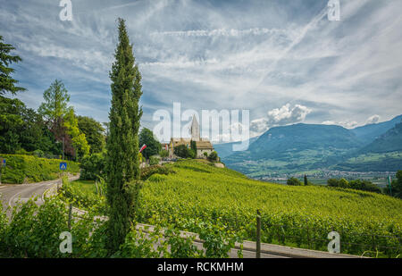 spring view of the Church of the idyllic village of Cortaccia ( Kurtatsch an der Weinstrasse ). Cortaccia extends on the sunny side of the wine road. Stock Photo