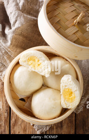 Chinese Steamed Creamy Custard Bun close-up on the table. Vertical top view from above Stock Photo