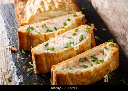 Sliced puff pastry pie stuffed with salmon and cheese close-up on the table. horizontal Stock Photo