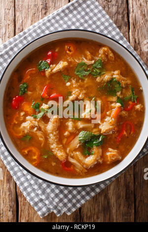 Flaki or flaczki is a traditional Polish meat stew close-up in a bowl on the table. Vertical top view from above Stock Photo