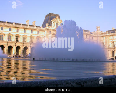 Palais du Louvre and ornamental fountain in the Cour Napoléon Stock Photo