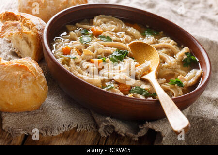 Flaki or flaczki is a traditional Polish meat stew close-up in a bowl on a table served with bread. horizontal Stock Photo