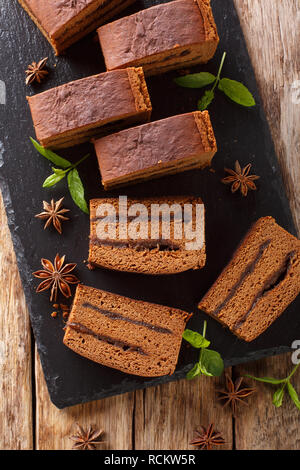 Polish festive cake piernik with plum jam close-up on the table. Vertical top view from above Stock Photo