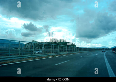 Quiet motorway with central barrier, stormy sky above Stock Photo
